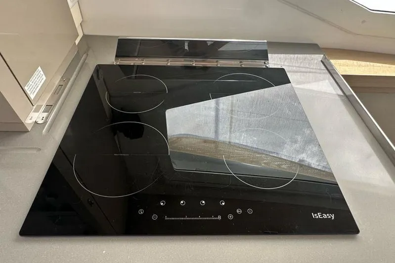 Waterlilly Yacht Photos Pics Modern black glass cooktop on 2017 Fountaine Pajot Lucia 40 yacht kitchen.