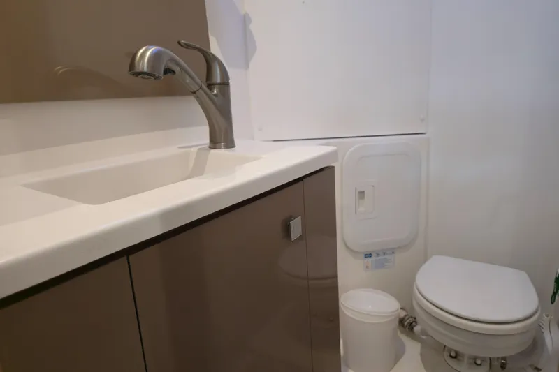 Waterlilly Yacht Photos Pics Bathroom interior of 2017 Fountaine Pajot Lucia 40 catamaran with sink and toilet.