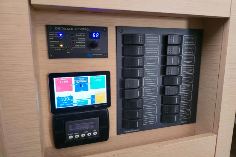 Waterlilly Yacht Photos Pics Control panel of a 2017 Fountaine Pajot Lucia 40 catamaran, featuring digital displays and switches.