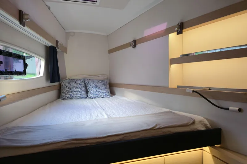 Waterlilly Yacht Photos Pics Cozy cabin interior of 2017 Fountaine Pajot Lucia 40 catamaran with bed and window view.