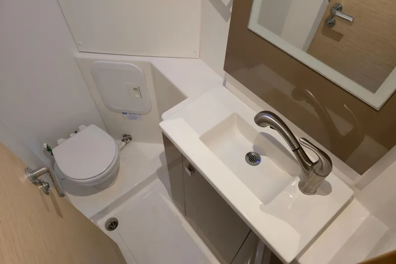 Waterlilly Yacht Photos Pics Bathroom interior of 2017 Fountaine Pajot Lucia 40 catamaran, featuring sink and toilet.