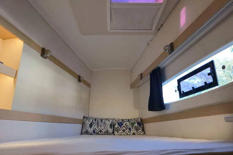 Waterlilly Yacht Photos Pics Cozy cabin interior of 2017 Fountaine Pajot Lucia 40 catamaran with window and bedding.