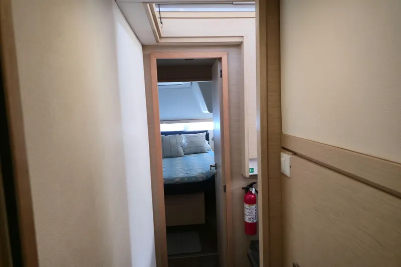 Waterlilly Yacht Photos Pics Interior view of 2017 Fountaine Pajot Lucia 40 yacht cabin with bed and fire extinguisher.