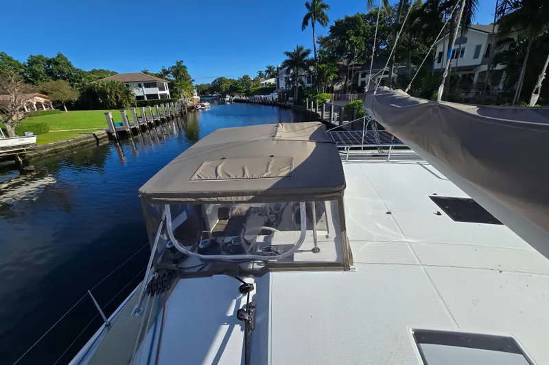 Waterlilly Yacht Photos Pics 2017 Fountaine Pajot Lucia 40 catamaran docked in a scenic canal setting.