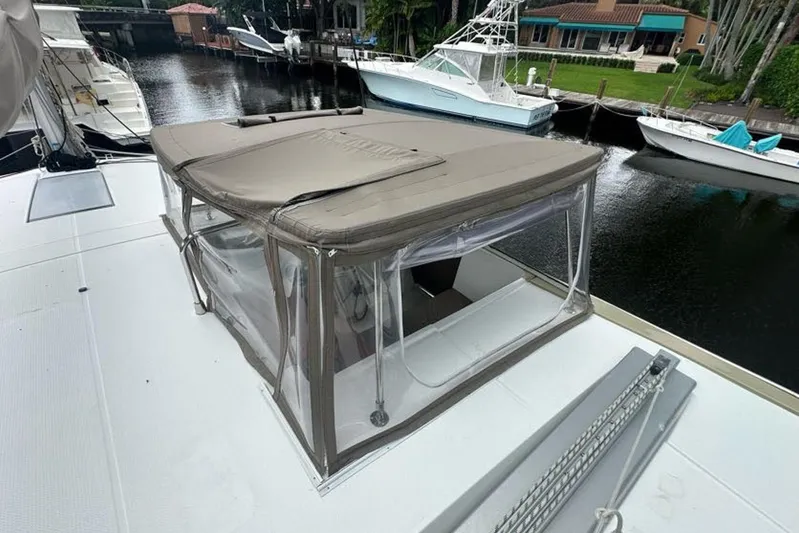 Waterlilly Yacht Photos Pics 2017 Fountaine Pajot Lucia 40 catamaran with covered cockpit, docked near other boats.