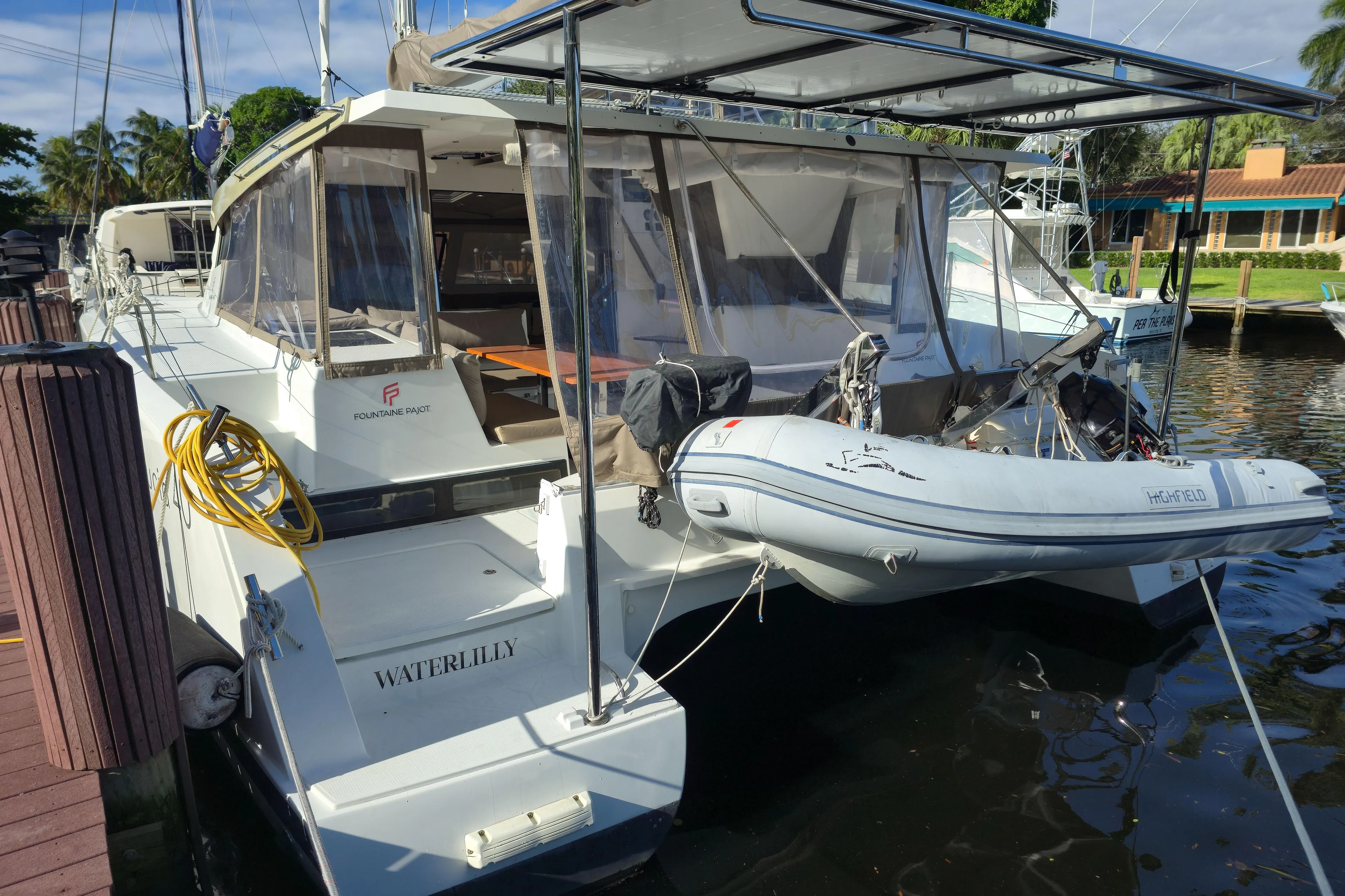 Waterlilly Yacht Photos Pics 2017 Fountaine Pajot Lucia 40 catamaran docked with dinghy attached.