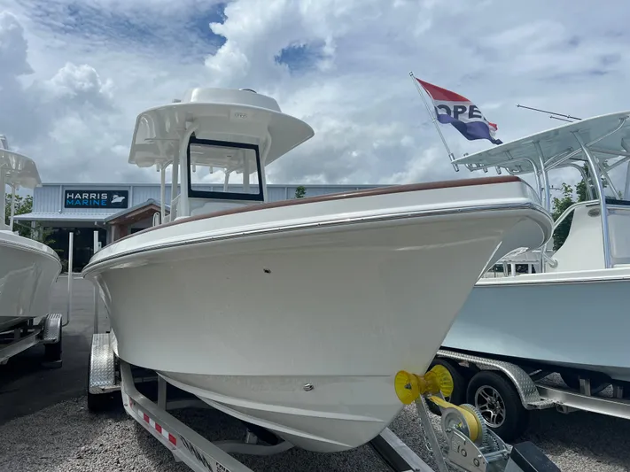  Yacht Photos Pics 2026 Pair Customs 27 Center Console boat on trailer at dealership, under cloudy sky.