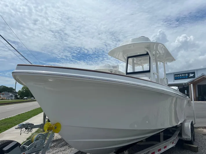  Yacht Photos Pics 2026 Pair Customs 27 Center Console boat on trailer under cloudy sky.