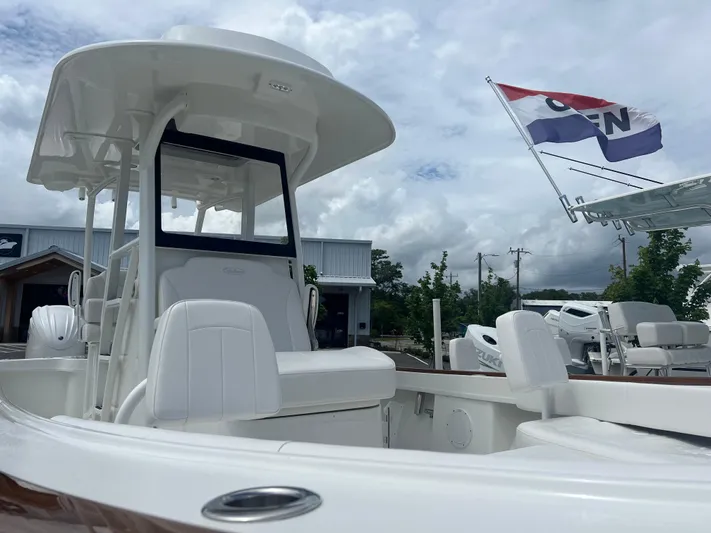  Yacht Photos Pics 2026 Pair Customs 27 Center Console boat with sleek design, docked under cloudy skies.