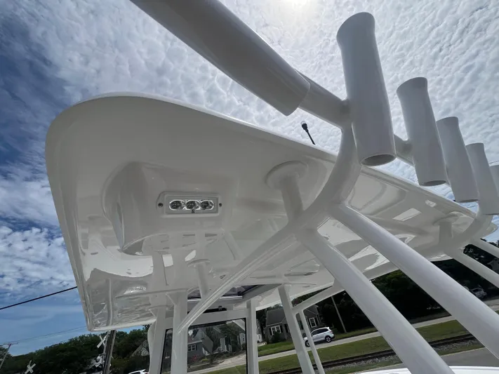  Yacht Photos Pics 2026 Pair Customs 27 Center Console boat with rod holders and sleek design under a cloudy sky.