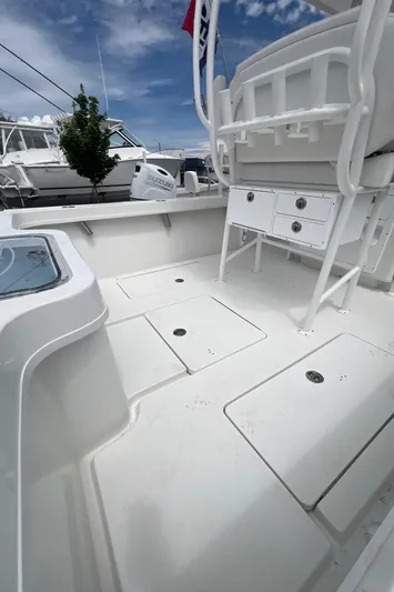  Yacht Photos Pics 2026 Pair Customs 27 Center Console boat interior with storage compartments and seating.