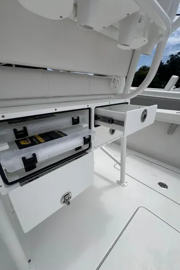  Yacht Photos Pics 2026 Pair Customs 27 Center Console boat storage compartments with tackle boxes.