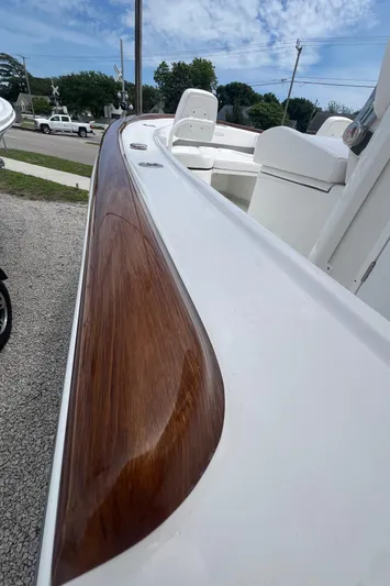  Yacht Photos Pics 2026 Pair Customs 27 Center Console boat with sleek wooden trim detail.