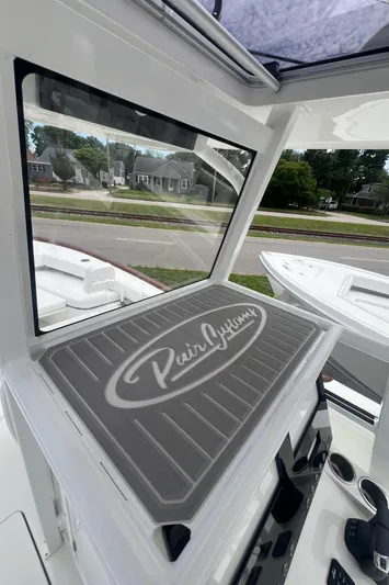  Yacht Photos Pics 2026 Pair Customs 27 Center Console boat interior with branded mat and window view.