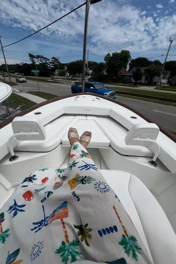  Yacht Photos Pics 2026 Pair Customs 27 Center Console boat with person relaxing, scenic view.