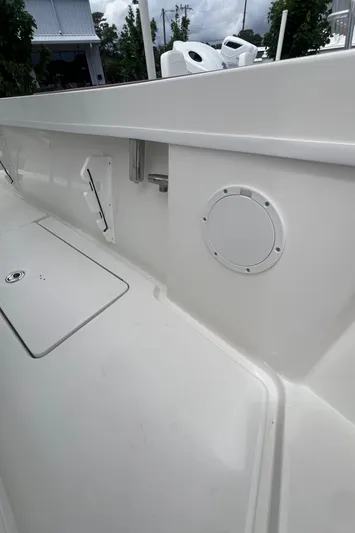  Yacht Photos Pics 2026 Pair Customs 27 Center Console boat interior, featuring sleek white design and storage compartments.