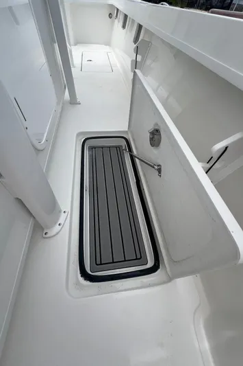  Yacht Photos Pics 2026 Pair Customs 27 Center Console boat interior with storage compartment open.