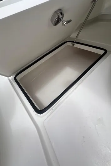  Yacht Photos Pics 2026 Pair Customs 27 Center Console boat storage compartment with open hatch.