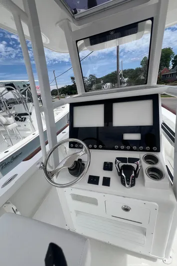  Yacht Photos Pics 2026 Pair Customs 27 Center Console boat interior with modern dashboard and steering wheel.