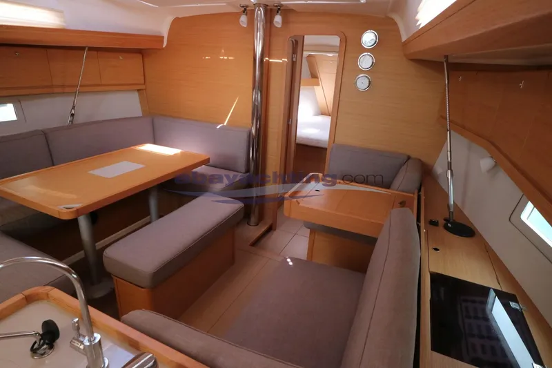  Yacht Photos Pics Interior of 2018 Dufour 412 Grand Large yacht with cozy seating and dining area.