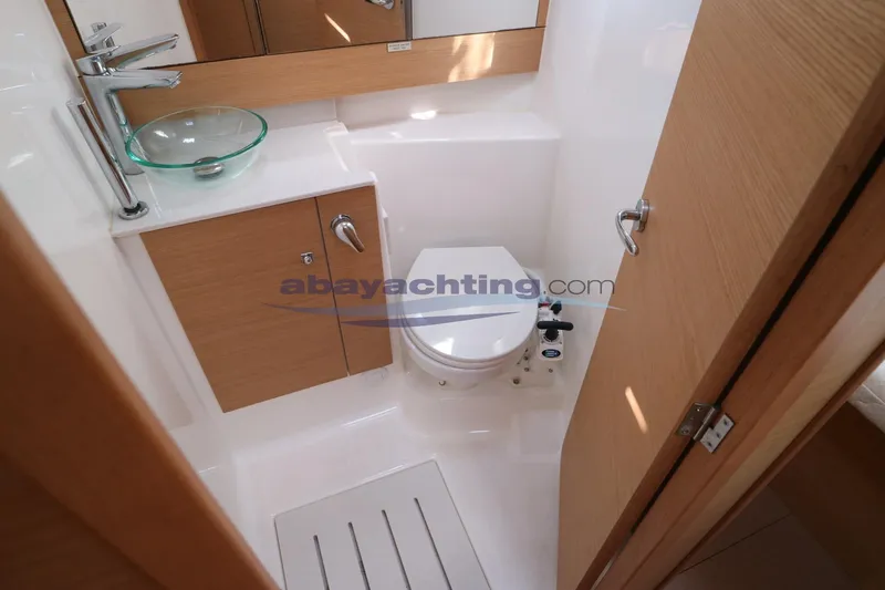  Yacht Photos Pics Bathroom interior of 2018 Dufour 412 Grand Large yacht, featuring modern fixtures and wooden cabinetry.