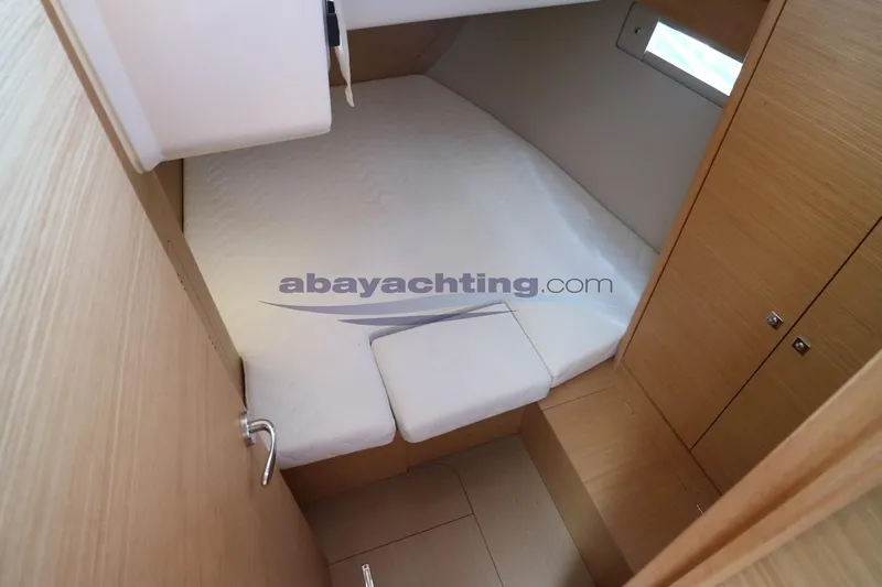  Yacht Photos Pics 2018 Dufour 412 Grand Large yacht cabin interior with bed and storage.