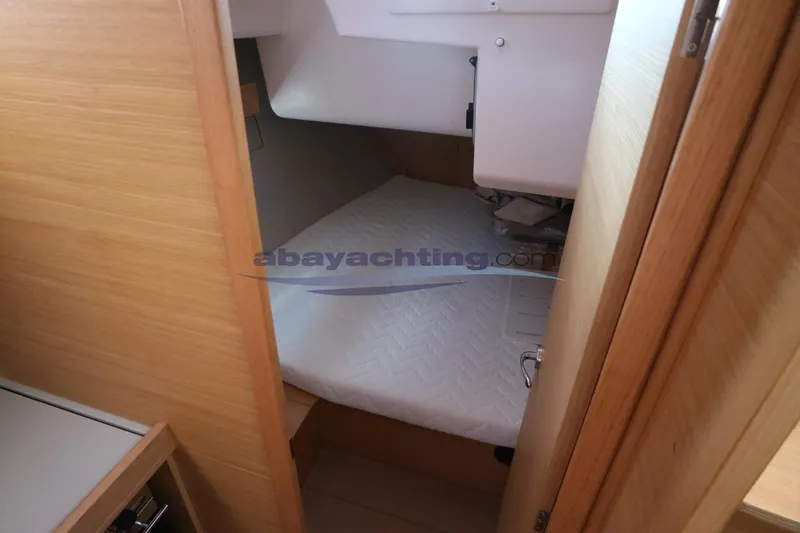  Yacht Photos Pics 2018 Dufour 412 Grand Large yacht cabin interior with wooden finish and cozy bed.
