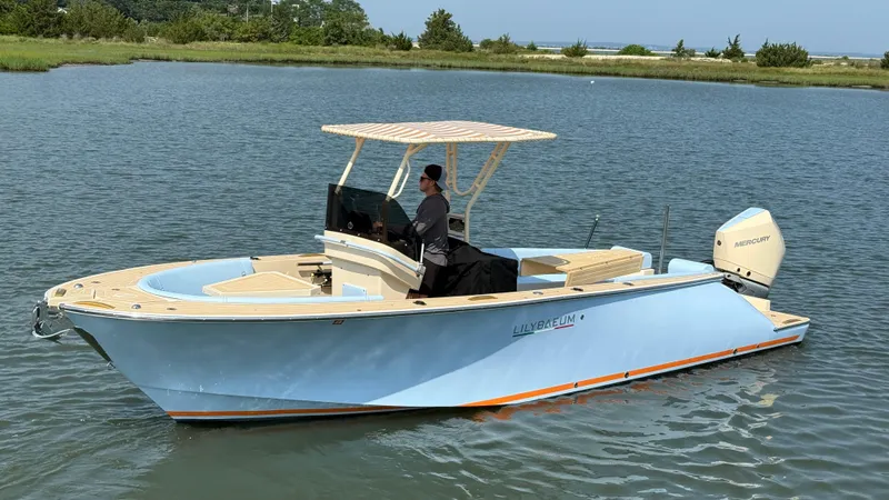  Yacht Photos Pics 2025 Lilybaeum Levenzo boat on calm water with a person steering.