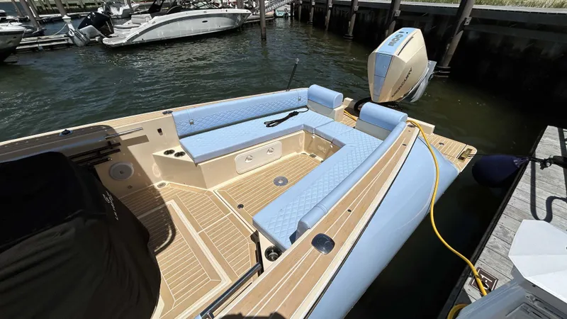  Yacht Photos Pics 2025 Lilybaeum Levenzo boat with blue seating, docked by the water.