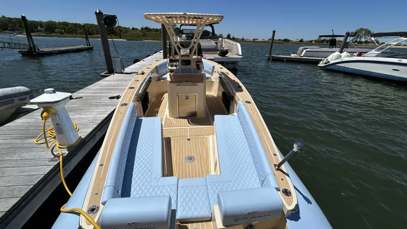 Yacht Photos Pics 2025 Lilybaeum Levenzo boat docked, featuring light blue seating and wooden deck.