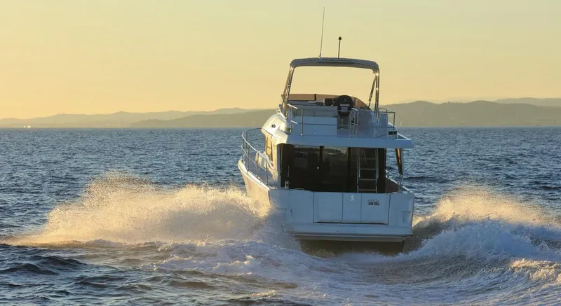 Vitamin Sea Yacht Photos Pics 2021 Beneteau Swift Trawler 35 cruising at sunset.