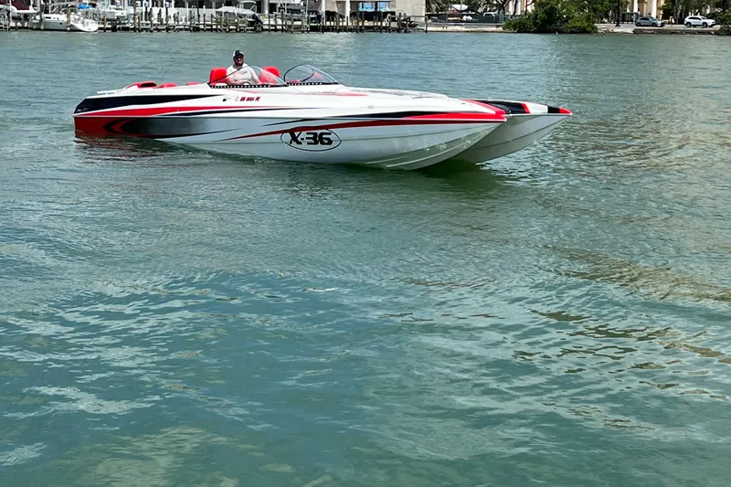  Yacht Photos Pics 2004 Spectre 36 Cat powerboat on calm water, featuring sleek red and white design.