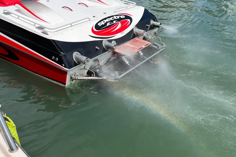  Yacht Photos Pics 2004 Spectre 36 Cat boat with water spray and rainbow effect.