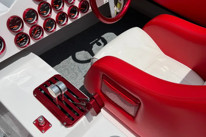  Yacht Photos Pics Interior of 2004 Spectre 36 Cat boat with red and white seats and multiple gauges.