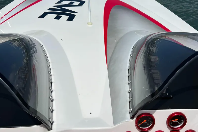  Yacht Photos Pics 2004 Spectre 36 Cat boat with sleek design and red accents on deck.