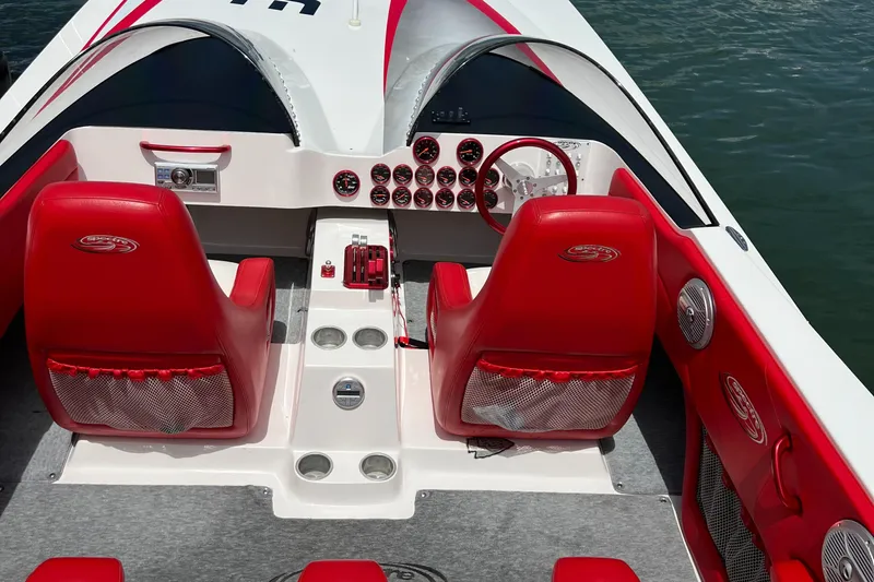  Yacht Photos Pics 2004 Spectre 36 Cat boat interior with red seats and dashboard controls.