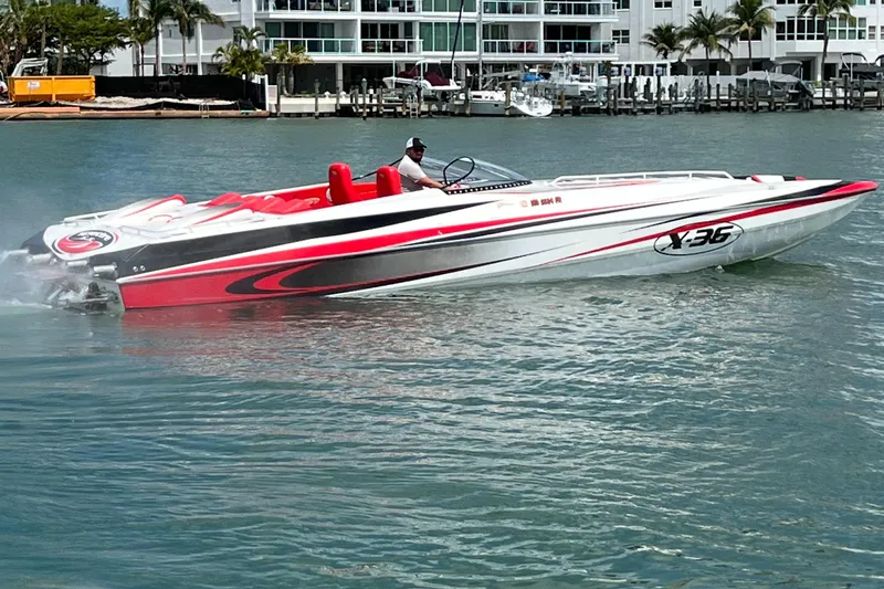  Yacht Photos Pics 2004 Spectre 36 Cat powerboat cruising on water, featuring sleek red and white design.