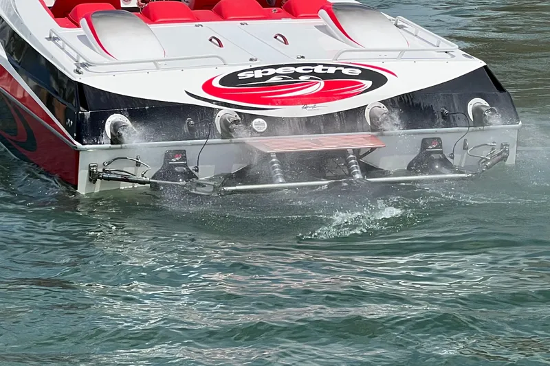  Yacht Photos Pics 2004 Spectre 36 Cat speedboat with red seats, cruising on water.