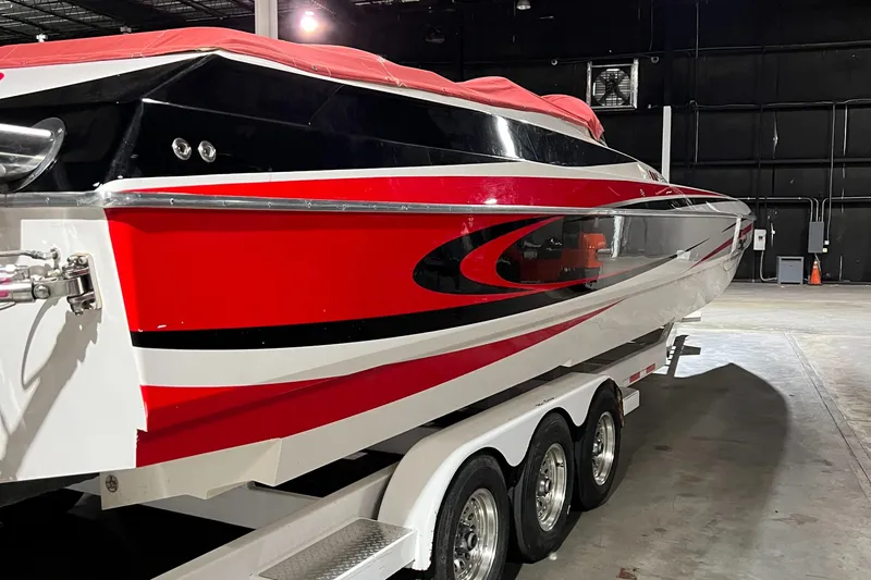  Yacht Photos Pics 2004 Spectre 36 Cat powerboat with red and black design on a triple-axle trailer.