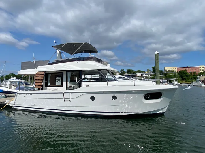  Yacht Photos Pics 2026 Beneteau 41 Swift Trawler FLY docked in a marina under cloudy skies.