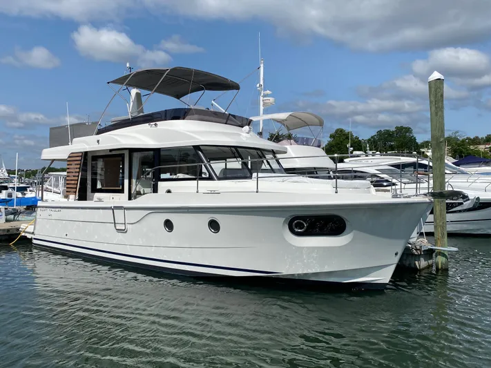  Yacht Photos Pics 2026 Beneteau 41 Swift Trawler FLY docked in marina under cloudy sky.