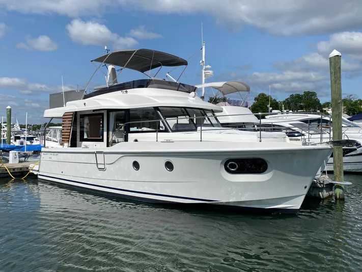  Yacht Photos Pics 2026 Beneteau 41 Swift Trawler FLY docked in a marina under a cloudy sky.