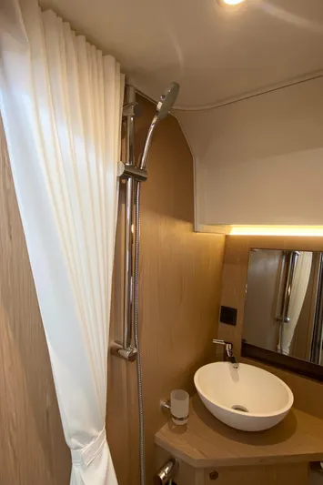  Yacht Photos Pics 2026 Beneteau 41 Swift Trawler FLY bathroom with modern sink and shower.
