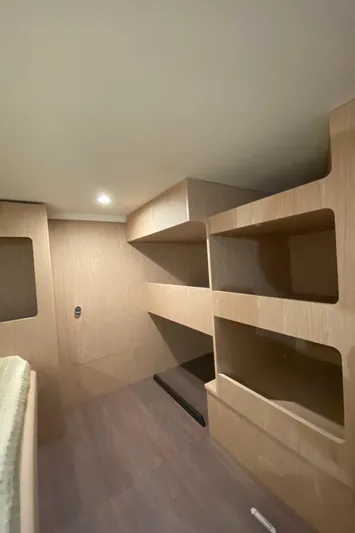  Yacht Photos Pics Interior of 2026 Beneteau 41 Swift Trawler FLY with modern wooden shelving.