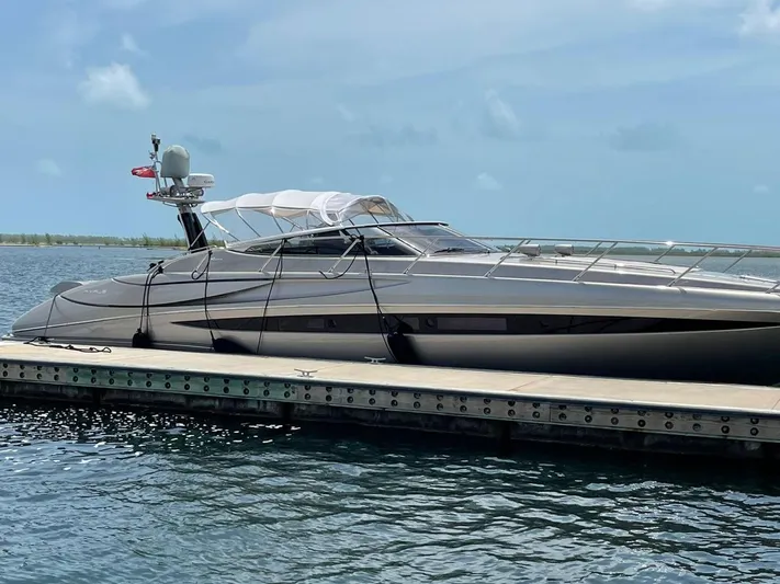  Yacht Photos Pics Luxury 2012 Riva Rivale yacht docked on calm water under clear skies.