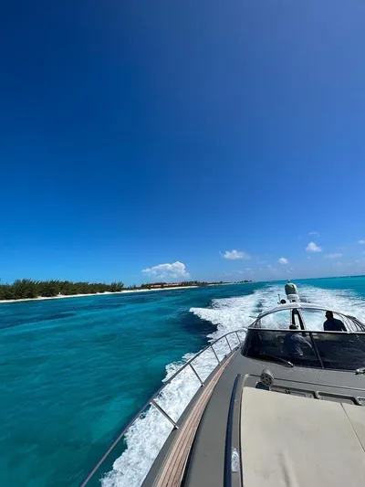  Yacht Photos Pics Luxury Riva Rivale 2012 yacht cruising on turquoise waters under clear blue sky.