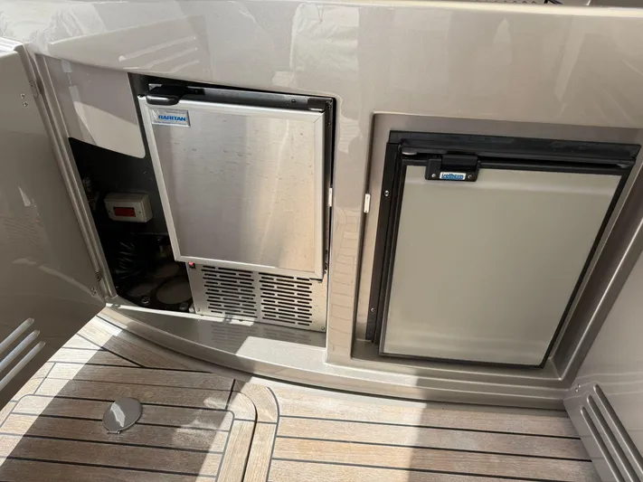  Yacht Photos Pics 2012 Riva Rivale yacht interior with built-in refrigeration units on teak flooring.