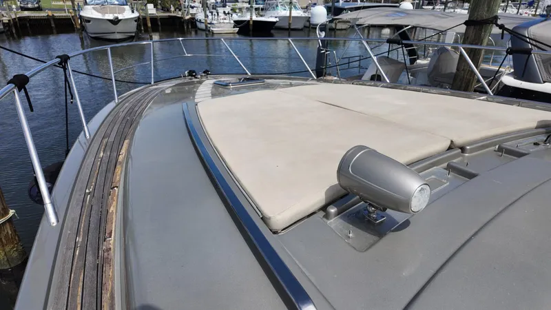  Yacht Photos Pics 2012 Riva Rivale yacht deck with sunpad and spotlight, docked in marina.
