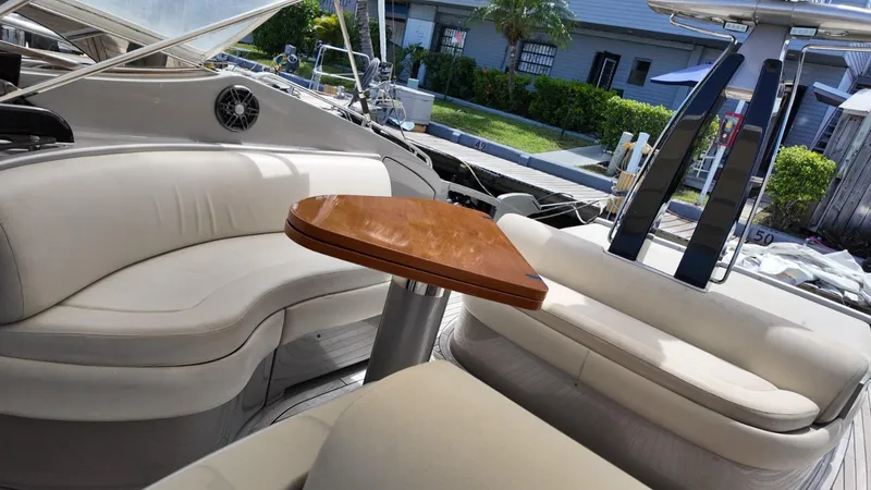  Yacht Photos Pics Luxurious 2012 Riva Rivale yacht interior with elegant seating and wooden table.