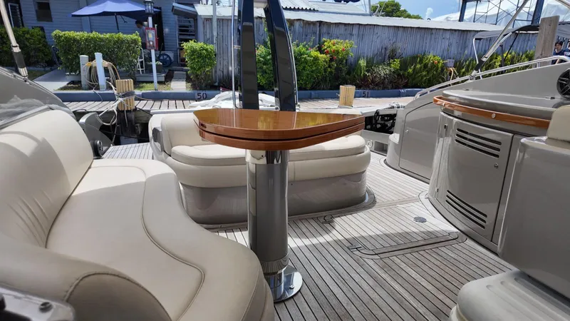  Yacht Photos Pics Luxurious 2012 Riva Rivale yacht interior with elegant seating and wooden table.
